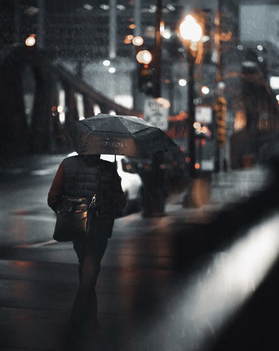 man w umbrella new york city night